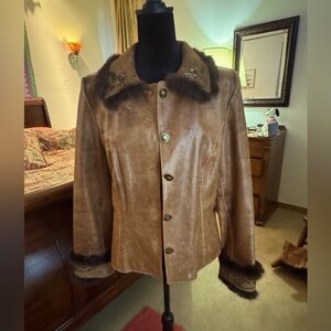 Vintage distressed leathered with mink beaded suede trim.  Size M